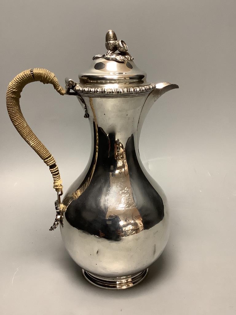 A Victorian silver baluster hot water jug, with acorn finial, by George Fox, London, 1876, height 25cm